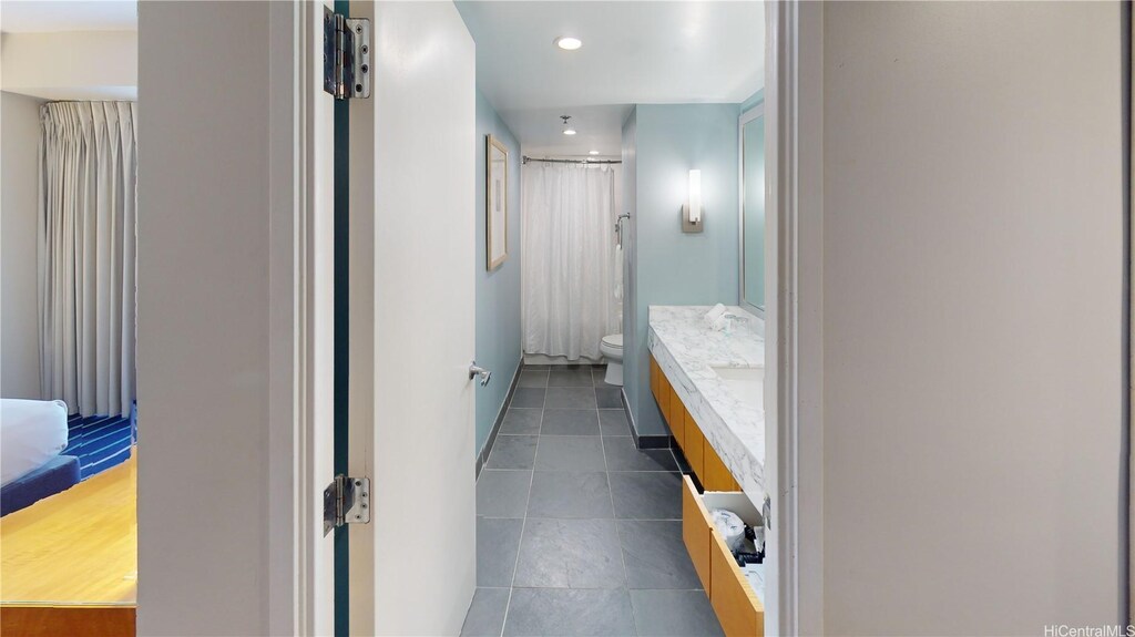full bath with a shower with curtain, recessed lighting, toilet, tile patterned floors, and vanity