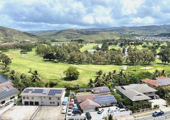 birds eye view of property with a mountain view and golf course view