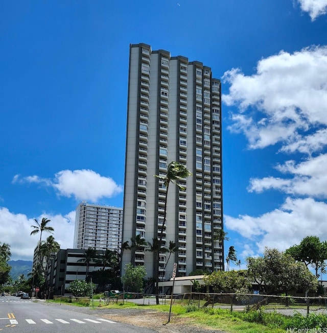 view of apartment building / complex with fence