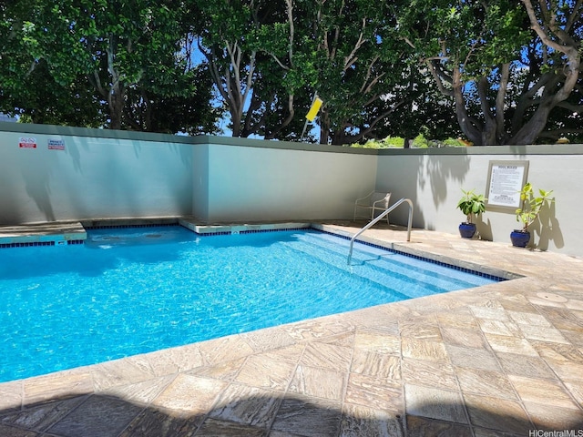 community pool with a patio area