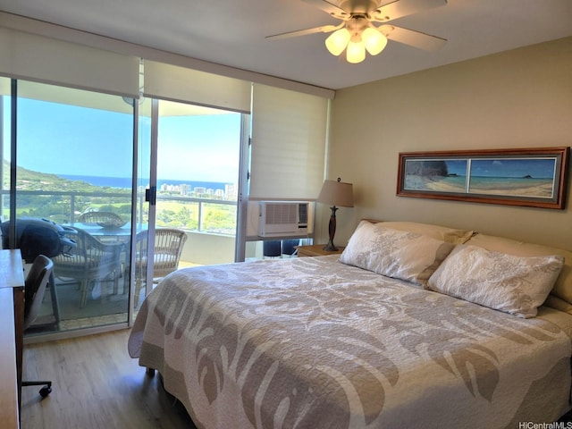 bedroom with access to exterior, wood finished floors, cooling unit, and a ceiling fan
