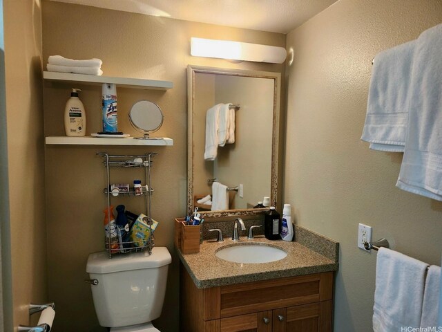 half bath featuring toilet and vanity