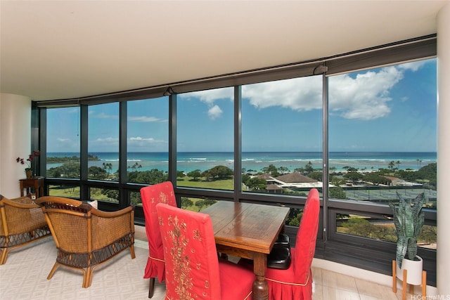 sunroom / solarium with a water view and expansive windows