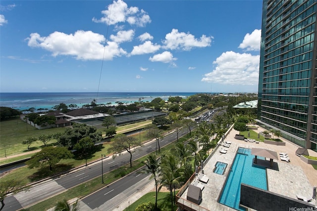 exterior space with a nearby body of water and a pool