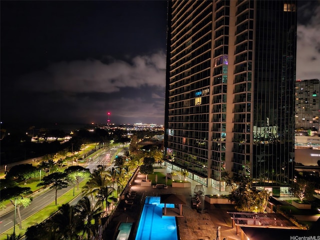 property at night featuring a view of city lights