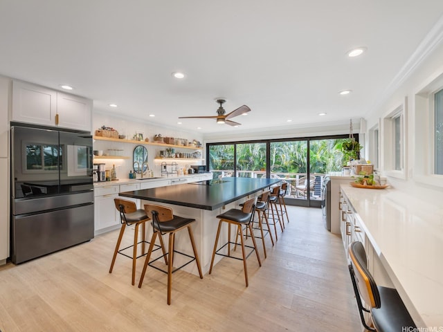 567 Kawailoa Rd Unit E, Kailua, HI 96734 - kitchen featuring a kitchen bar, open shelves, crown molding, light wood-style floors, and white cabinets