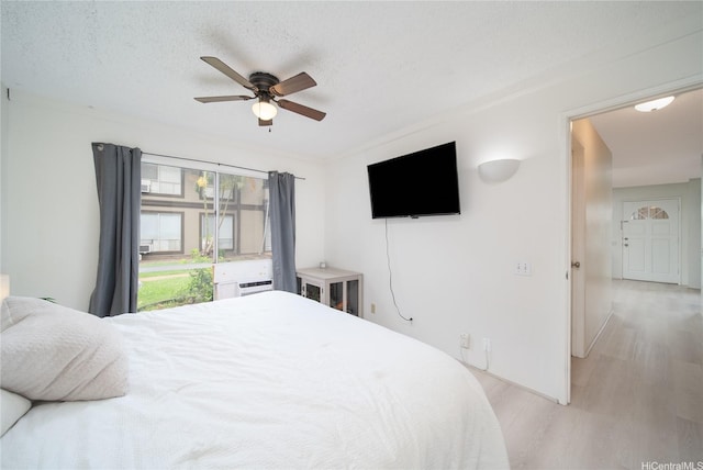 91-1180 Puamaeole St Unit 10A, Ewa Beach, HI 96706 - bedroom featuring light wood finished floors, a ceiling fan, and a textured ceiling
