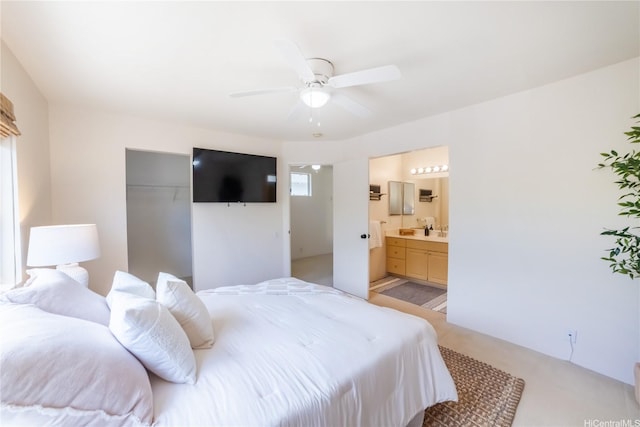 bedroom with ensuite bath, ceiling fan, and a closet