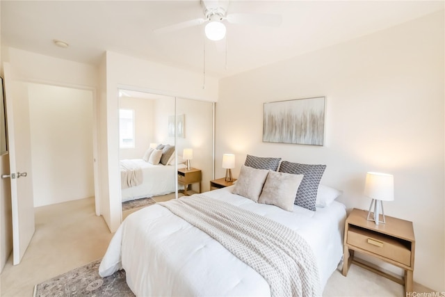 carpeted bedroom with a closet and a ceiling fan