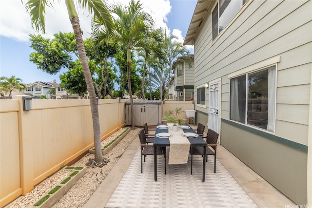 view of patio with outdoor dining space and a fenced backyard