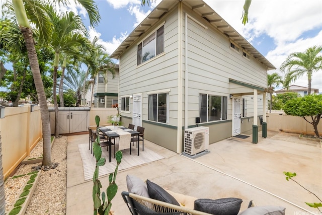back of property with a cooling unit, a patio, a gate, and a fenced backyard
