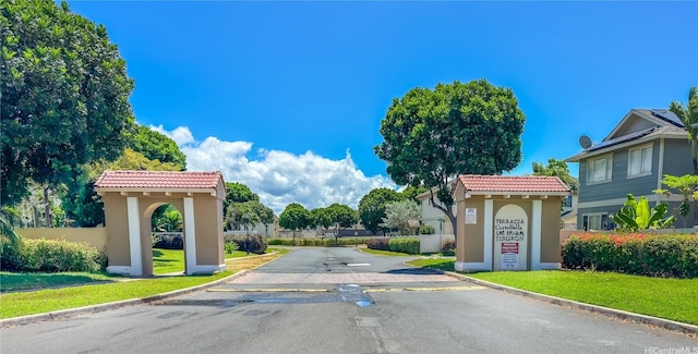 view of asphalt street with curbs