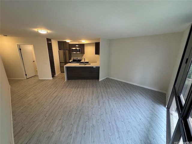 1441 Piikoi St Unit 206, Honolulu, HI 96822 - kitchen featuring appliances with stainless steel finishes, a sink, light countertops, and baseboards
