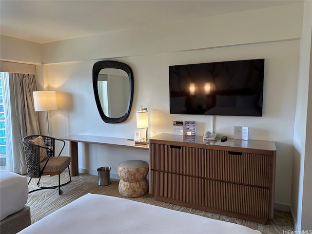 bedroom with baseboards and wood finished floors