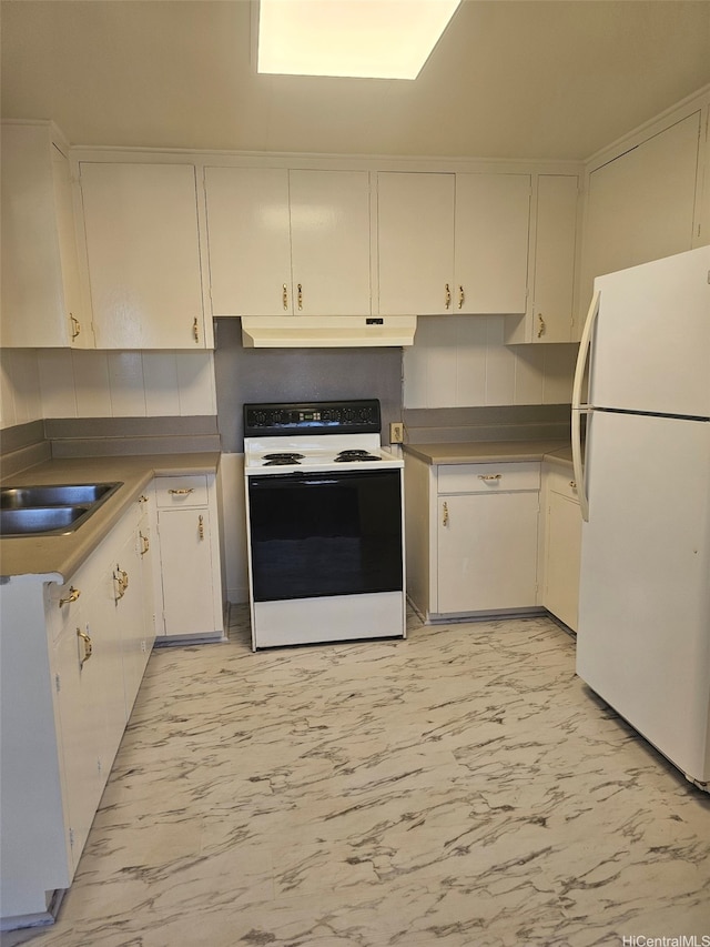 kitchen featuring freestanding refrigerator, white cabinets, under cabinet range hood, marble finish floor, and range with electric stovetop