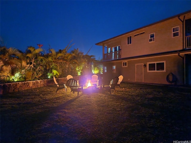 47-285 Waihee Rd Unit D, Kaneohe, HI 96744 - back of house at twilight featuring a fire pit and a balcony