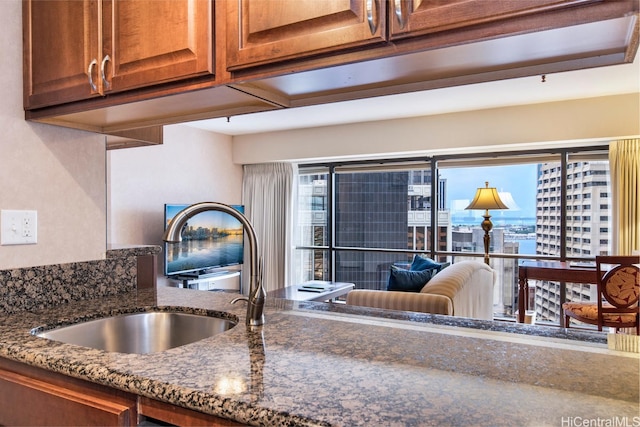 1088 Bishop St Unit 2006, Honolulu, HI 96813 - kitchen view of a sink, dark stone counters, and brown cabinets