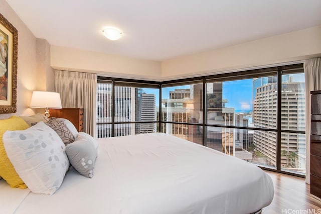 1088 Bishop St Unit 2006, Honolulu, HI 96813 - bedroom with wood finished floors and a view of city