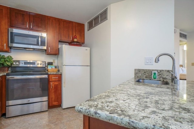 1088 Bishop St Unit 3706, Honolulu, HI 96813 - kitchen featuring stainless steel appliances, a sink, light stone counters, and a peninsula