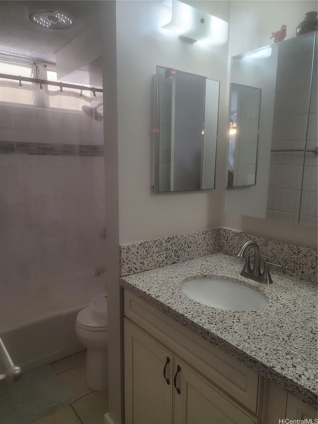 full bath featuring tile patterned floors, toilet, vanity, and shower / washtub combination