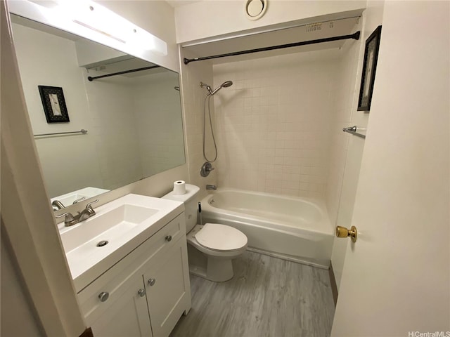 bathroom featuring wood finished floors, vanity, and bathing tub / shower combination
