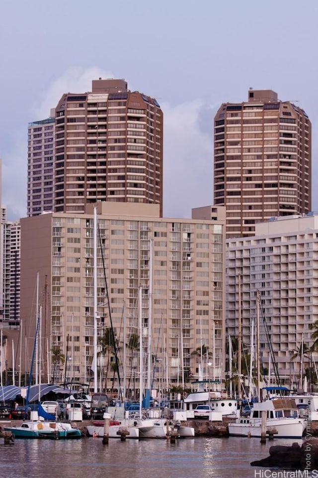 view of building exterior featuring a water view and a view of city