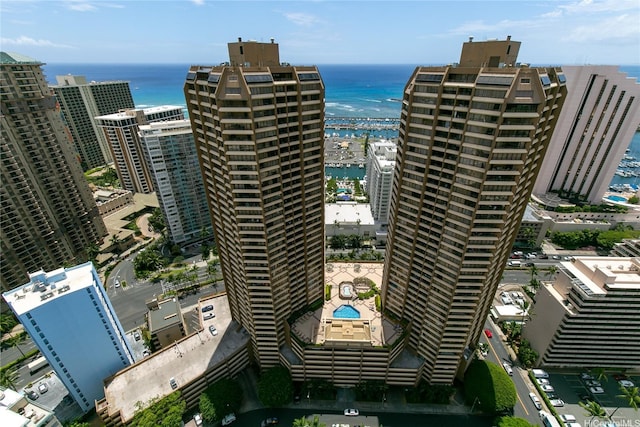 view of urban area with a nearby body of water and a pool area