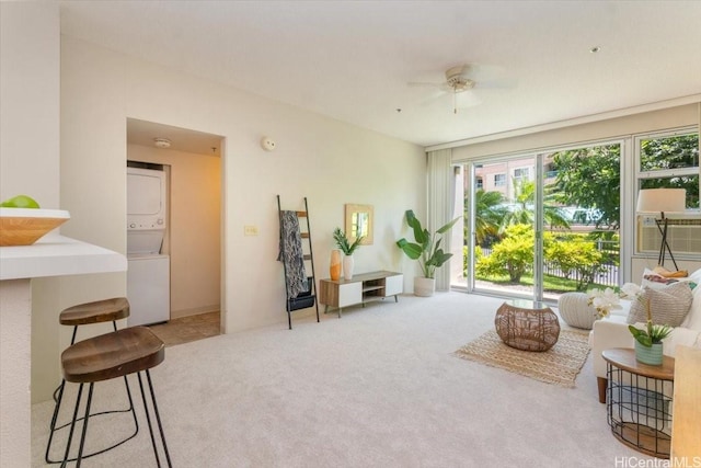 3009 Ala Makahala Pl Unit 102, Honolulu, HI 96818 - sitting room featuring stacked washer and clothes dryer, carpet, healthy amount of natural light, and a ceiling fan