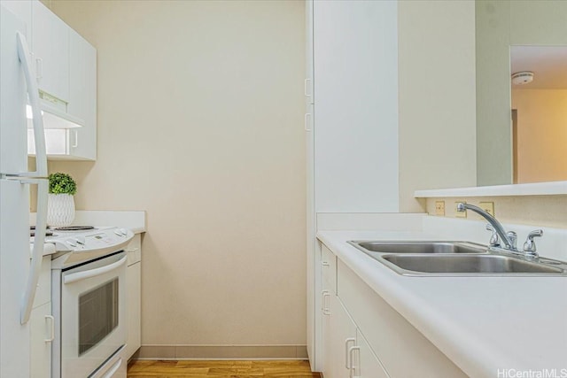 3009 Ala Makahala Pl Unit 102, Honolulu, HI 96818 - kitchen featuring white appliances, a sink, light wood finished floors, light countertops, and white cabinetry