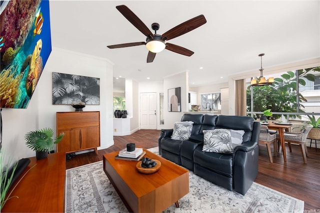 living area featuring wood finished floors, recessed lighting, ceiling fan, crown molding, and baseboards