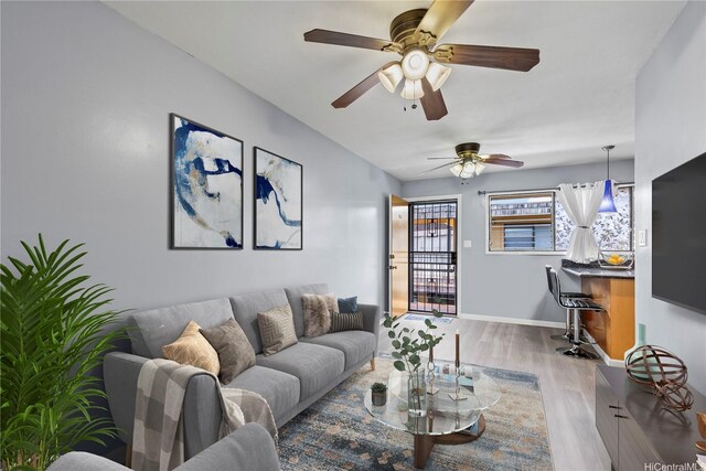 3003 Ala Napuaa Pl Unit 401, Honolulu, HI 96818 - living room with wood finished floors, a ceiling fan, and baseboards