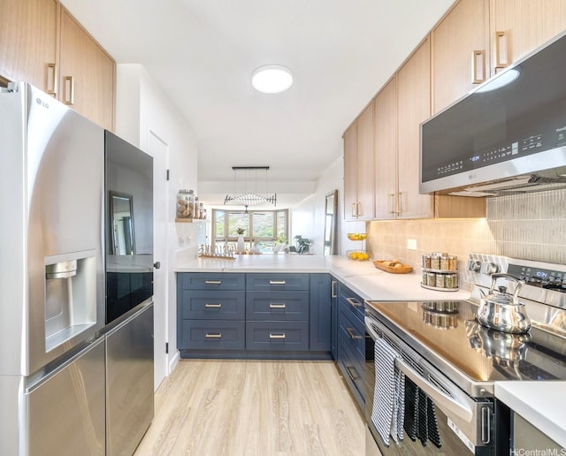 501 Hahaione St Unit 111D, Honolulu, HI 96825 - kitchen with stainless steel appliances, light wood-style floors, decorative backsplash, and light countertops