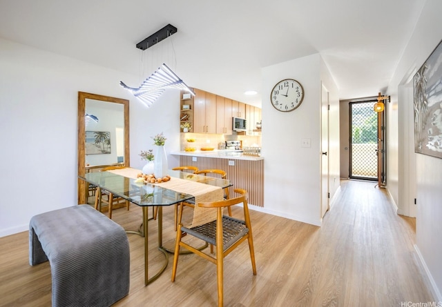 501 Hahaione St Unit 111D, Honolulu, HI 96825 - dining space with light wood-type flooring and baseboards