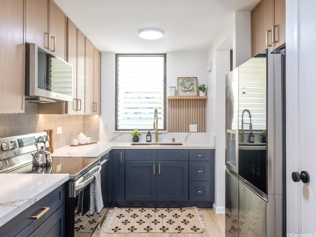 501 Hahaione St Unit 111D, Honolulu, HI 96825 - kitchen featuring appliances with stainless steel finishes, a sink, tasteful backsplash, light stone counters, and light wood-style floors