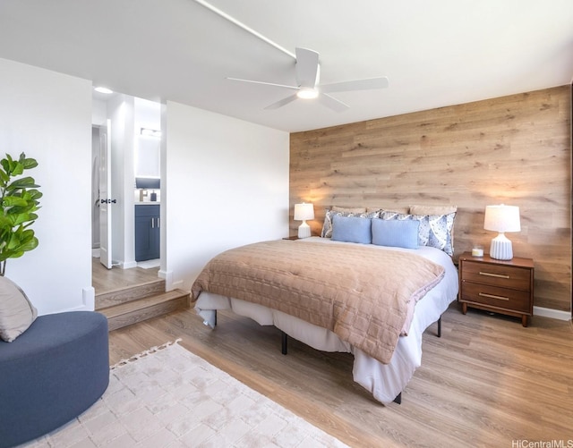 501 Hahaione St Unit 111D, Honolulu, HI 96825 - bedroom featuring wooden walls, light wood-style flooring, ceiling fan, and baseboards