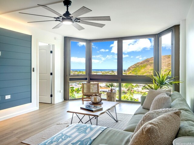 501 Hahaione St Unit 111D, Honolulu, HI 96825 - living area with floor to ceiling windows, healthy amount of natural light, wood finished floors, and a ceiling fan