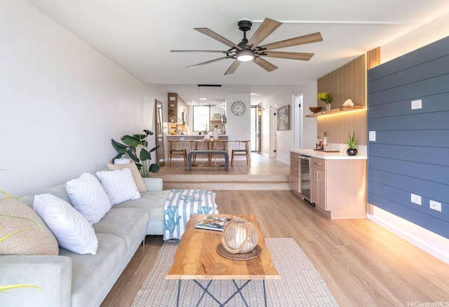 501 Hahaione St Unit 111D, Honolulu, HI 96825 - living area with light wood-style floors, a ceiling fan, and beverage cooler