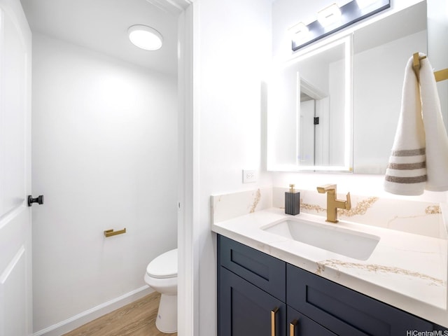 501 Hahaione St Unit 111D, Honolulu, HI 96825 - bathroom featuring toilet, wood finished floors, vanity, and baseboards