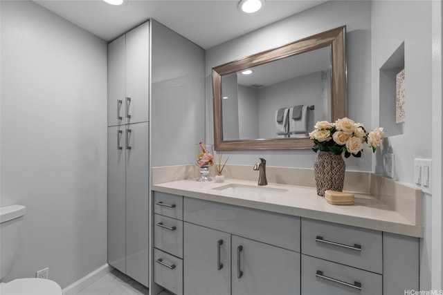 750 Kaheka St Unit 901, Honolulu, HI 96814 - bathroom featuring toilet, vanity, marble look tile flooring, baseboards, and recessed lighting