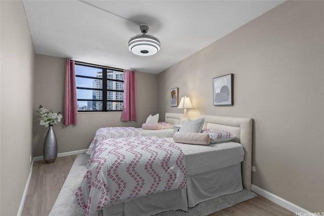 750 Kaheka St Unit 901, Honolulu, HI 96814 - bedroom featuring baseboards and wood finished floors