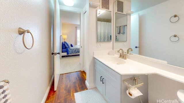 92-1226 Palahia St Unit Cc105, Kapolei, HI 96707 - bathroom featuring wood finished floors, vanity, and baseboards