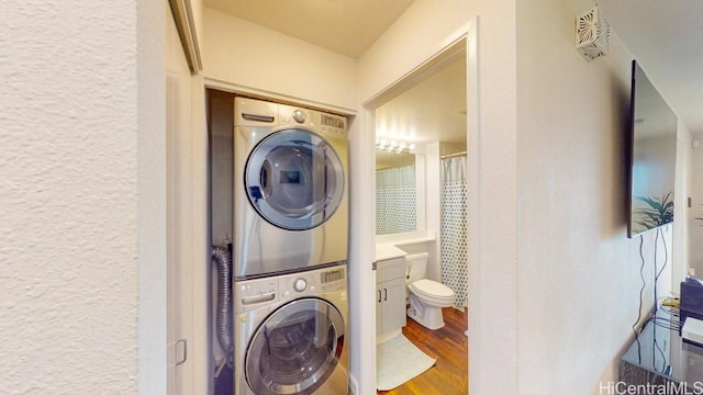92-1226 Palahia St Unit Cc105, Kapolei, HI 96707 - laundry room with estacked washer and dryer, wood finished floors, and a textured wall