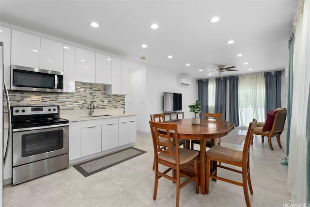 45-333 Mahalani St, Kaneohe, HI 96744 - kitchen featuring stainless steel appliances, a sink, modern cabinets, white cabinetry, and decorative backsplash
