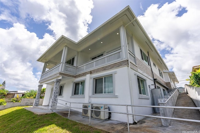 45-333 Mahalani St, Kaneohe, HI 96744 - view of property exterior featuring a balcony, ac unit, a patio, and stucco siding
