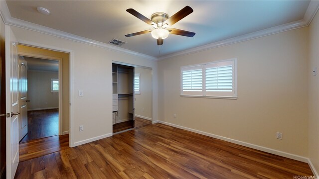 84-575 Kili Dr Unit 8, Waianae, HI 96792 - unfurnished bedroom featuring wood finished floors, crown molding, multiple windows, and baseboards