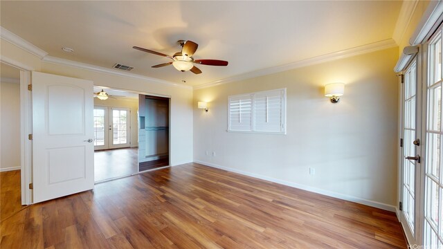 84-575 Kili Dr Unit 8, Waianae, HI 96792 - spare room featuring french doors, a ceiling fan, wood finished floors, crown molding, and baseboards