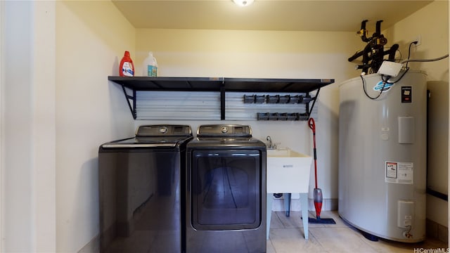 84-575 Kili Dr Unit 8, Waianae, HI 96792 - laundry room featuring electric water heater, washer and clothes dryer, and light tile patterned floors