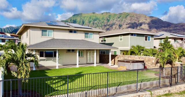 84-575 Kili Dr Unit 8, Waianae, HI 96792 - rear view of property featuring a mountain view, solar panels, a patio, french doors, and a shingled roof