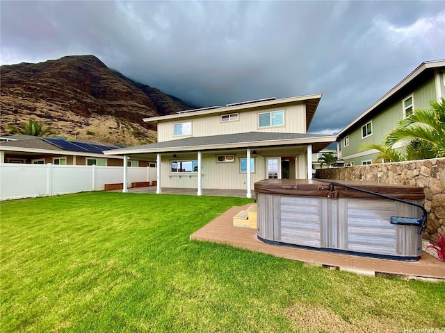 84-575 Kili Dr Unit 8, Waianae, HI 96792 - rear view of property featuring a hot tub, a mountain view, a patio area, and a ceiling fan