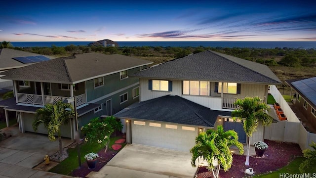 84-575 Kili Dr Unit 8, Waianae, HI 96792 - view of front of house featuring driveway, a shingled roof, fence, a balcony, and an attached garage